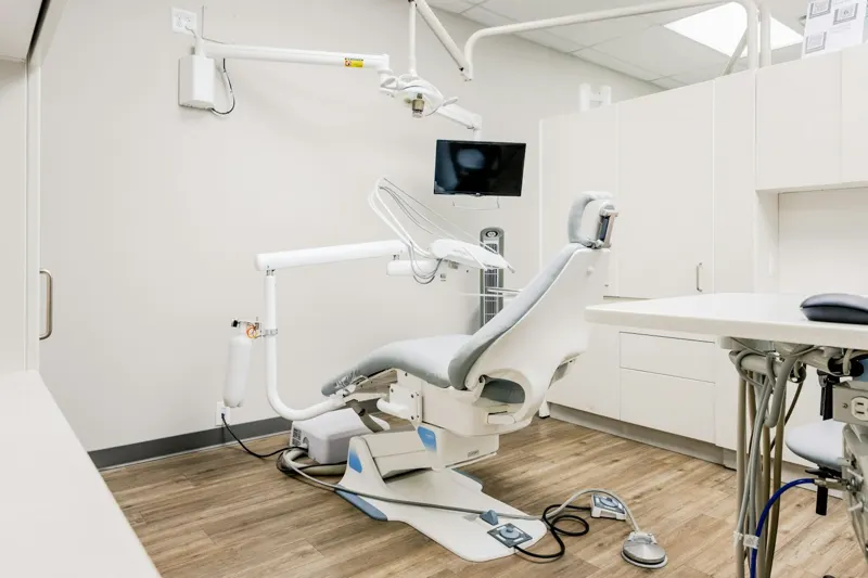 Sala de consulta dental con escritorio y sillón